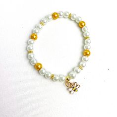 Beaded bracelet made from 6mm beads in gold and pearl with a cute bee charm. apprx diameter 7in please message if you would like a different size Pearl Bead Bracelet, Bee Charms, Bead Bracelet, Pearl Beads, Bracelet Making, Beaded Bracelet, Halloween Shopping, Unique Jewellery, Beauty Book