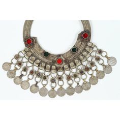 A Moroccan Tribal jewelry vintage a chocker inlaid with colorful glass beads in red and green and dangling coins. Silver, but not of the standard of sterling and richly embellished with applied silver designs and filigree.  Chocker size: 10" height x 10" wide including coins. chocker only is 8" x 8". German nickel coin silver. A Moroccan beautiful ethnic metal silvered jewelry choker.It is a traditional piece of jewelry that is worn around the neck handmade by skilled artisans in Morocco and ref Traditional Red Filigree Jewelry, Ornate Red Jewelry For Festivals, Traditional Coin Necklaces As Collectibles, Traditional Coin Necklaces For Collectors, Bohemian Jewelry With Coin Pendant For Collectible, Collectible Red Medallion Jewelry, Traditional Red Round Pendant Jewelry, Traditional Red Medallion Necklace, Bohemian Red Filigree Jewelry