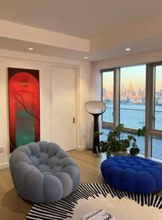 a living room filled with furniture and large windows