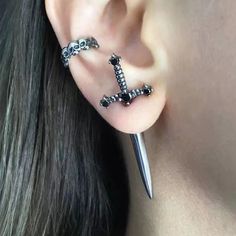 a close up of a person's ear with two piercings