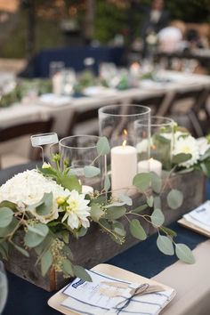 the table is set with candles, flowers and napkins for dinner guests to enjoy