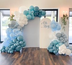 balloon arch with blue and white balloons on it