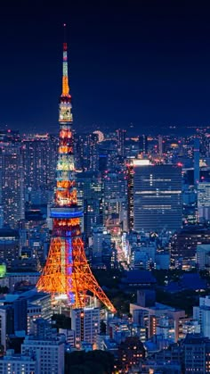 the eiffel tower lit up at night with city lights in the back ground