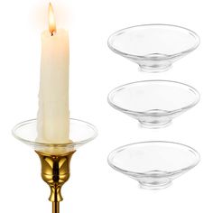 three glass plates and a candle on a stand