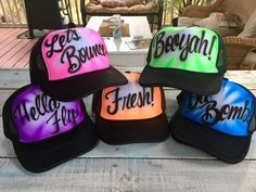 four hats with the words, hey byen'em on them sitting on a table