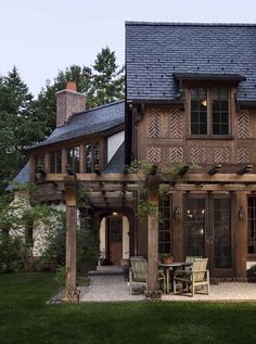 a large wooden house with an attached patio