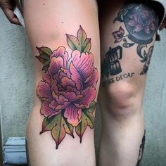 two people with tattoos on their legs and one has a flower tattoo on the leg