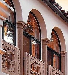 an ornate balcony and balconies on the side of a building with arched windows