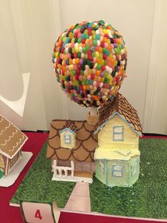 there is a cake made to look like a house with a tree on top that has candy in it