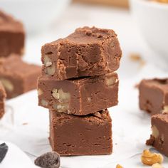 three pieces of chocolate fudge with nuts on the side