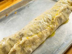 a long piece of food sitting on top of a pan