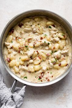 a pot filled with chicken and dumplings covered in gravy on top of a table