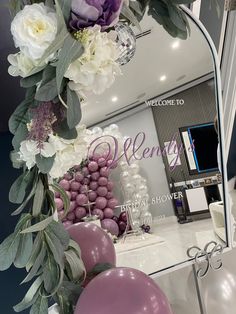 a mirror with flowers and balloons in front of it