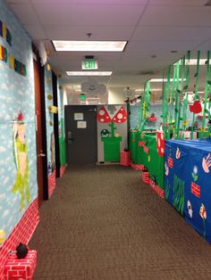 an office decorated for the holidays with paper streamers on the walls and decorations hanging from the ceiling