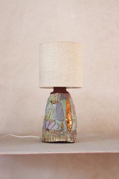 a lamp sitting on top of a shelf