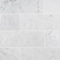 a white marble tile wall and floor