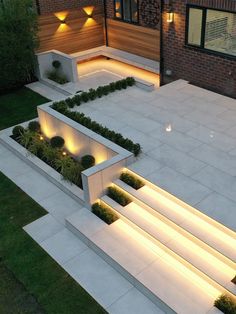 an aerial view of a modern garden with lights on the steps and plants growing in the planters