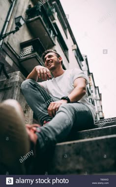 a man is sitting on the steps outside