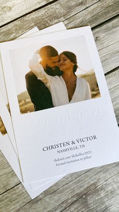 three wedding save the dates cards sitting on top of a wooden table next to each other