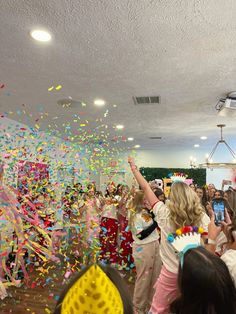 a group of people celebrating with confetti and streamers in front of them