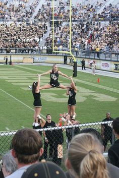 the cheerleaders are performing on the field for the crowd to see them perform