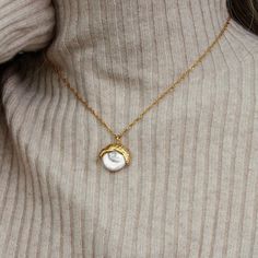 Capture the essence of celestial elegance with the Aurora Pearl Pendant Necklace. Featuring a luminous baroque pearl cradled beneath a textured 18k gold-plated cap, this piece strikes the perfect balance between natural beauty and refined craftsmanship. The waterproof design ensures effortless wear, whether dressing for an elegant evening or a casual daytime look. Hypoallergenic and thoughtfully crafted, it promises a comfortable fit and lasting brilliance. Composition:Ethically sourced Stainless Steel-Plated 18k Gold and Genuine Freshwater Pearls.Water, Sweat, and Heat Resistant. (No discoloration, No Tarnishing).Hypoallergenic and skin-friendly.Comes in an eco-friendly package.Measurement:Length: 16 InchesWeight: 7 g Gold Baroque Pearl Round Pendant Jewelry, Gold Baroque Pearl Necklace With Round Pendant, Baroque Pearl Clavicle Chain Jewelry Gift, Gold Baroque Pearl Jewelry, Luxury Baroque Pearl Jewelry For Gifts, Luxury Baroque Pearl Jewelry Gift, Dainty Gold Jewelry With Baroque Pearl, Dainty Baroque Pearl Gold Jewelry, Gold Baroque Pearl Jewelry For Anniversary