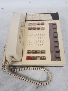 an old style telephone sitting on the ground