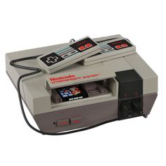 an old school video game console with two controllers on it's top and bottom