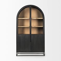 an arch shaped bookcase with wooden shelves and glass doors on the front, against a white background