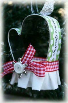 a christmas tree ornament with a red and white checkered ribbon on it