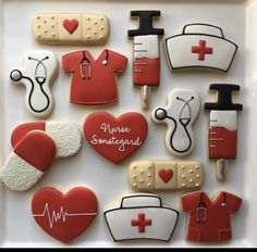 decorated cookies in the shape of nurse's uniforms and medical equipment on a plate