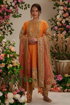 Peach orange georgette long anarkali with intricate gota work in floral pattern. Comes with matching salwar and pure organza dupatta.
Components: 3
Pattern: Embroidered
Type Of Work: Gota
Neckline: Round
Sleeve Type: Three Quarter
Fabric: Anarkali and Salwar: Georgette, Dupatta: Organza
Color: Peach,Orange
Other Details: 
Embellished show buttons
Kiran border dupatta
Model height: 5ft 7inches, wearing size S
Closure:
Kurta: Front hook and eye
Salwar: Drawstring tie-up
Occasion: Wedding,Puja - Az Orange Anarkali Suits, Peach Colour Combinations Indian Dress, Orange Suits Women Indian, Orange Punjabi Suit, Salwar Georgette, Gota Work Dress, Surface Development, Orange Anarkali, Peach Anarkali