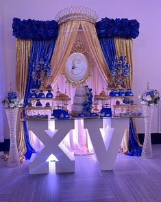 a blue and gold wedding dessert table