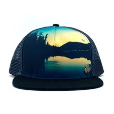 Unisex low-profile trucker hat. Graphic print image of Juniper Lake at Lassen National Park. Adjustable snap with mesh back. Outdoor Snapback Hat, Flat Bill Baseball Cap For Camping, Adjustable Flat Bill Baseball Cap For Camping, Adjustable Snapback Baseball Cap For Camping, Flat Bill Snapback Hat For Camping, Outdoor Snapback Baseball Cap, Adjustable Flat Brim Trucker Hat For Camping, Adjustable Snapback Hat For Camping With Flat Bill, Outdoor Flat Bill Snapback Hat