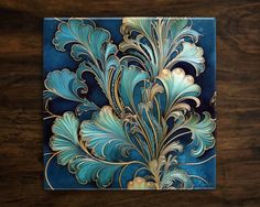 a blue and gold art piece on a wooden table