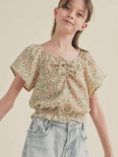 This Short Sleeve Cinched Floral Top for tweens is perfect for adding a pop of color to any outfit. Made with high-quality material, it features a flattering cinched waist and a beautiful floral pattern. Dress it up or down for any occasion. Expertly designed for both style and comfort. 100% Polyester Brand: Moonpink Casual Tops With Gathered Waist And Short Sleeves, Spring Cotton Tops With Gathered Waist, Fall Vest, Floral Pattern Dress, Womens Cami, Pattern Dress, Flutter Sleeve Top, Pop Of Color, Kids Sleepwear