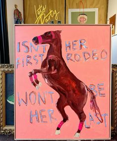 a pink sign with a horse painted on it