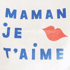 a white bag with blue and red writing on it that says mama je t'aime