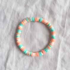 a bracelet with multicolored beads on a white surface, in the shape of a circle