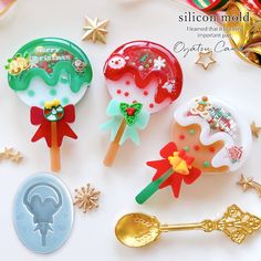 three christmas lollipops are sitting next to each other on a white surface