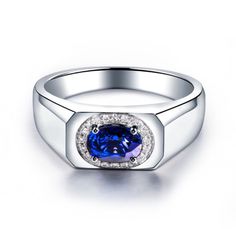 a white gold ring with a blue sapphire and diamonds