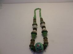 "Vintage 1930's Deco ethnic all glass multi shaped beads with brass details. Fabulous jadite green emerald green white middle bead has pink and blue flowers. 16\" brass details. fabulous looking necklace! condition is great, there is one knotted string coming through top of bead, not unusual with this type of thing." Jadite Green, Pink And Blue Flowers, Vintage Art Glass, Delicate Earrings, Green Emerald, Emerald Green, Blue Flowers, Art Glass, Vintage Art