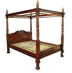 an antique four poster bed with wooden posts