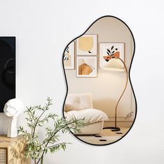 a mirror reflecting a living room with a couch and table in front of the mirror