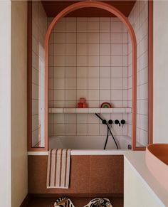 a pair of shoes sitting on the floor in front of a bathtub