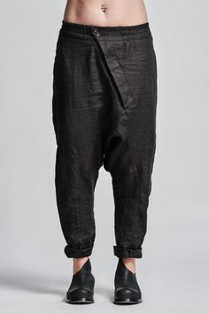 "Denim Drop Crotch Boiled Linen Trousers With Elastic Waistband__ // EXPRESS DELIVERY ONLY __Cropped Length __Asymmetrical Hidden Front Closure __Rear Bonded Panel __2 Front & 2 Rear Pockets __Elastic Waistband __Fully Completed Stitching model__ bust 92 (36\"), waist 72 (28\"), hips 102 (40\"), biceps 28 (11''), height 177 (5'8\"), kg 65 (143 lbs) model wears size M | color: black fabric__ 100 linen care__ dry cleaning do not bleach do not tumble dry do not iron to keep wrinkle effect sizin Black Tapered Bottoms For Spring, High Waist Black Linen Pants, Black Linen Tapered Leg Bottoms, Black Linen High-waisted Pants, Black High-waisted Linen Pants, Fitted Black Linen Bottoms, Linen Bottoms With Belt Loops, Urban Clothing Men, High Collar Jacket