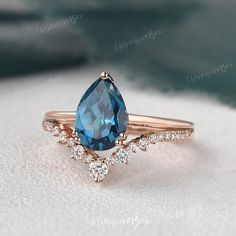 a ring with a blue topaz surrounded by diamonds