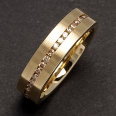 a gold ring with white diamonds on it