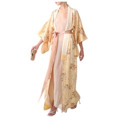 Vintage Japanese kimono in 100% silk  Handmade in Japan Floor length Pale peach with coloured print Comes with a blush pink silk ribbon that gives you the option to wear this open or closed  FREE SHIPPING WORLDWIDE!!! Composition: 100% Silk Size: ONE SIZE  - Will fit a XS - L depending on how oversized you desire the fit  Some small faint marks to the body and lining that are shown in detail in the photographs - Please note that these get lost amongst the print and are barely visible when worn. Pink Silk Ribbon, Informal Dress, Kimono Floral, Over Coat, Kimono Vintage, Designer Coats, 18th Century Fashion, Pale Peach, Vintage Japanese Kimono