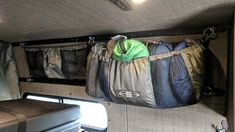 the inside of a camper with two bags hanging from it's side wall